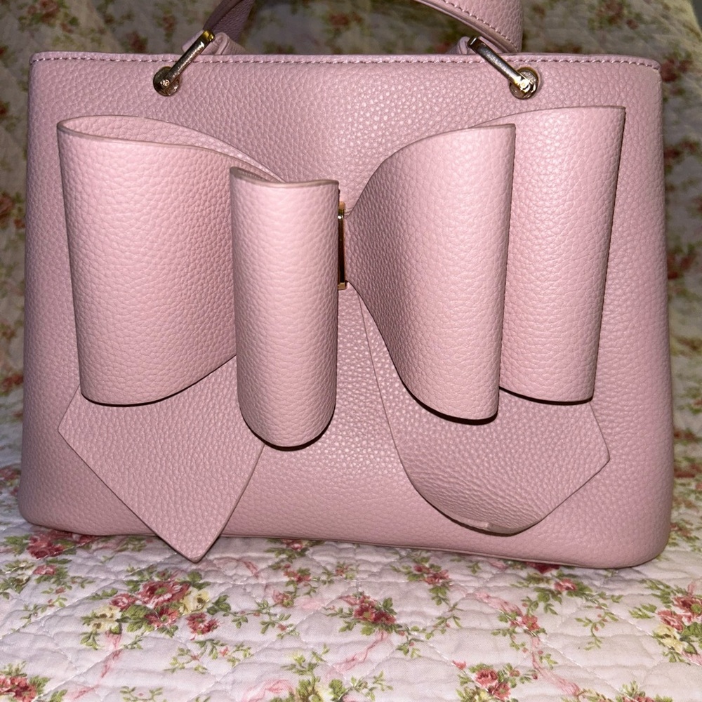 Gently used pink bow bag; purchased from TJ Maxx